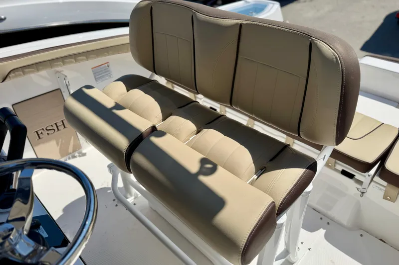 Slide: The Image of 2026 Yamaha Boats 255 FSH Sport H, featuring sleek white deck design and storage compartment. - 9