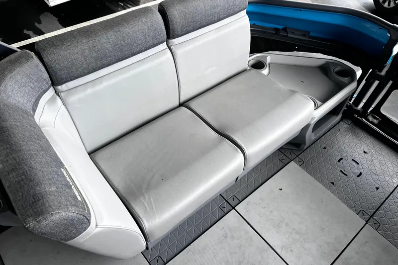 Slide: The Image of 2023 Sea-Doo Switch Cruise 18 interior seating with cup holders and gray upholstery. - 11
