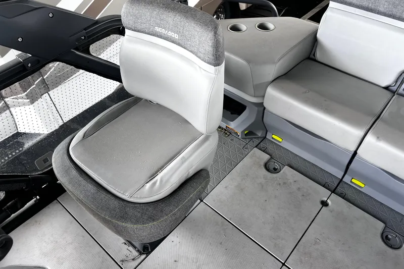 Slide: The Image of Interior seating of 2023 Sea-Doo Switch Cruise 18, featuring gray cushioned seats and cup holders. - 13