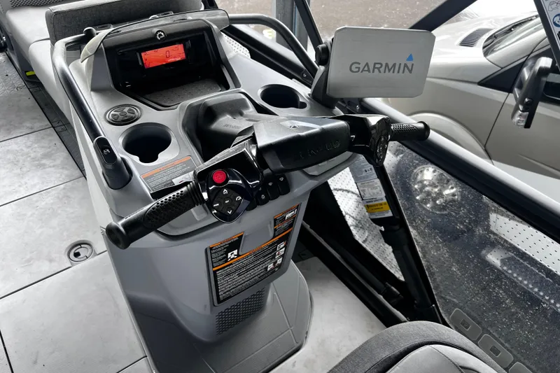 Slide: The Image of 2023 Sea-Doo Switch Cruise 18 dashboard with Garmin navigation system and controls. - 15