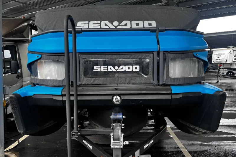 Slide: The Image of 2023 Sea-Doo Switch Cruise 18 pontoon boat on trailer in covered storage. - 9