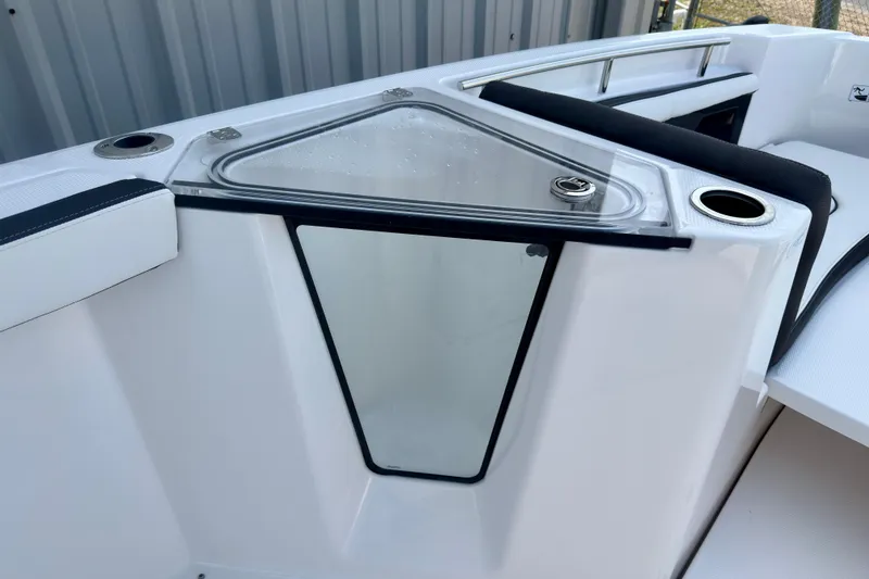 Slide: The Image of 2026 Yamaha Boats 255 FSH Sport H interior detail with cup holders and storage compartment. - 13
