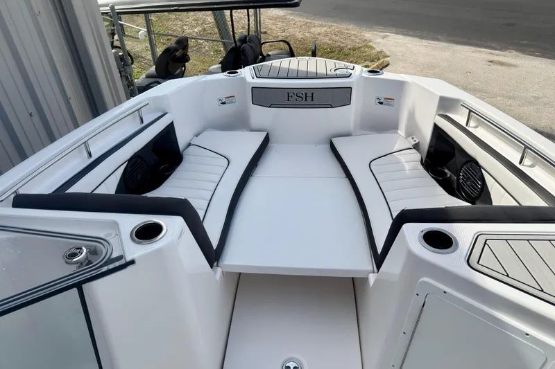 Slide: The Image of 2026 Yamaha Boats 255 FSH Sport H interior with seating and cup holders. - 14