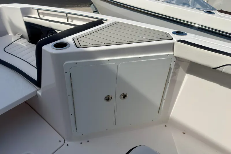 Slide: The Image of 2026 Yamaha Boats 255 FSH Sport H interior with storage compartment and seating area. - 15