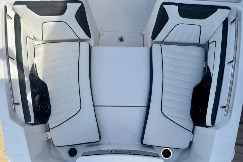 Slide: The Image of 2026 Yamaha Boats 255 FSH Sport H interior seating, featuring sleek white and black design. - 21
