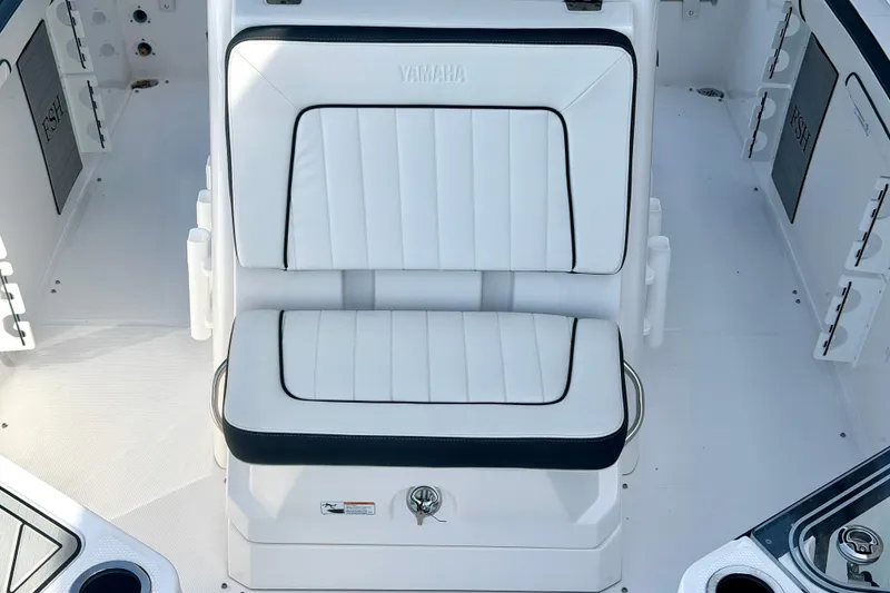 Slide: The Image of 2026 Yamaha Boats 255 FSH Sport H interior with white cushioned seating. - 22