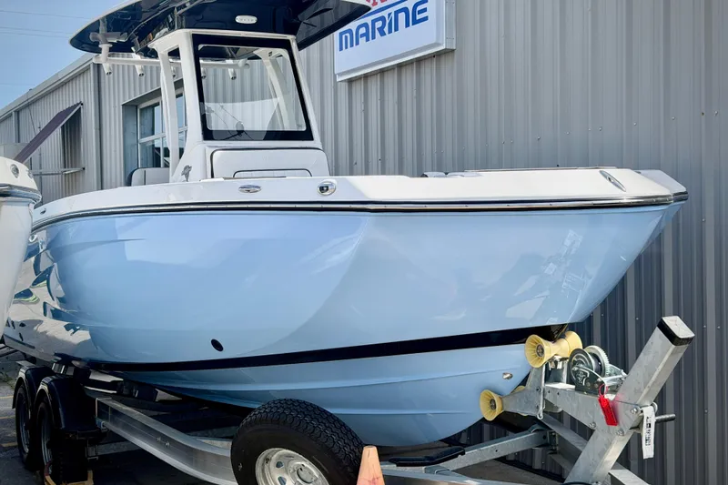 Slide: The Image of 2026 Yamaha Boats 255 FSH Sport H on trailer, displayed outside a marine dealership. - 26