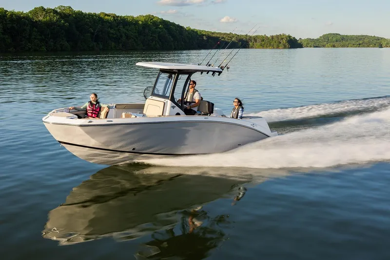Slide: The Image of Manufacturer Provided Image: 2026 Yamaha Boats 255 FSH Sport H cruising on a serene lake with passengers. - 28
