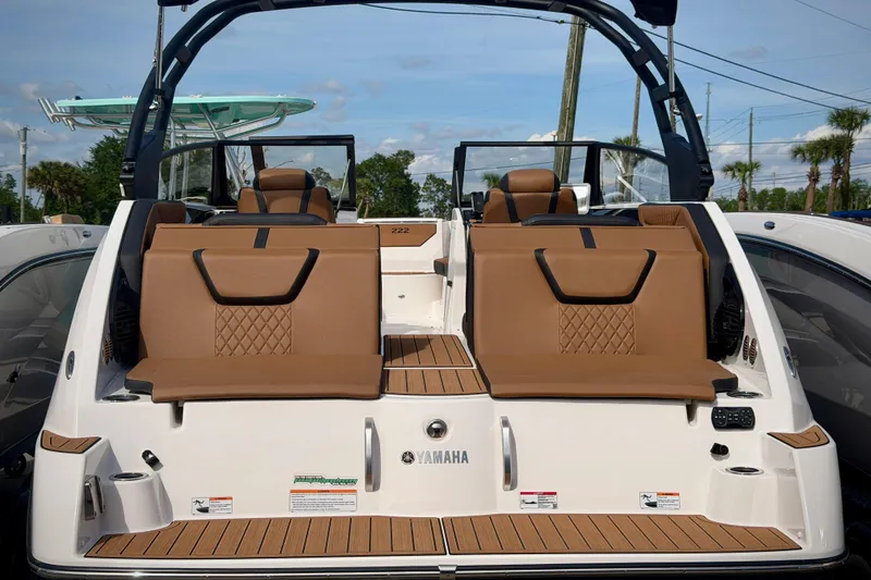 Slide: The Image of 2026 Yamaha Boats 222SD with luxurious seating and sleek design, docked outdoors. - 17