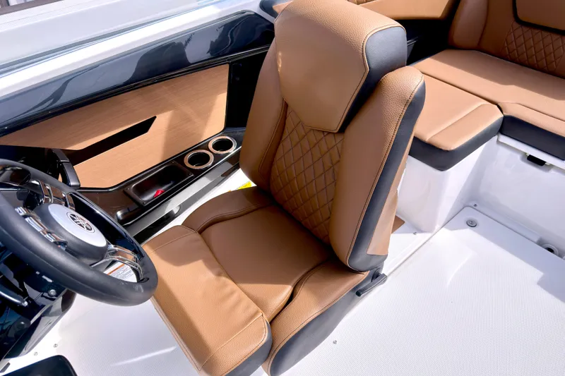 Slide: The Image of 2026 Yamaha Boats 222SD interior with luxurious tan seating and sleek steering wheel design. - 19