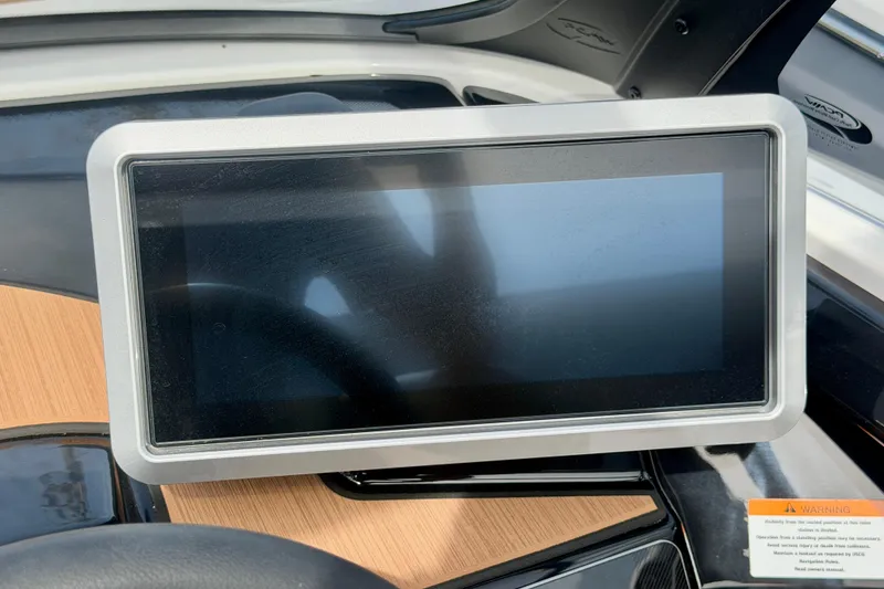 Slide: The Image of Touchscreen display on 2026 Yamaha Boats 222SD dashboard, featuring sleek design and wood accents. - 22