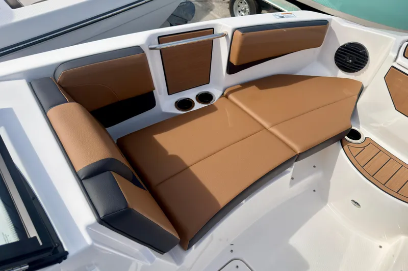 Slide: The Image of 2026 Yamaha Boats 222SD interior with tan and black seating, cup holders, and speaker. - 25
