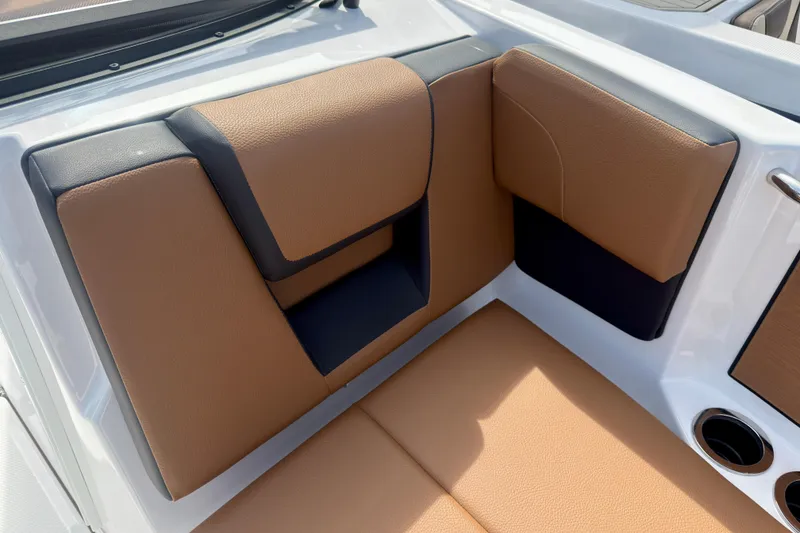 Slide: The Image of 2026 Yamaha Boats 222SD interior seating with tan and black upholstery, featuring cup holders. - 32