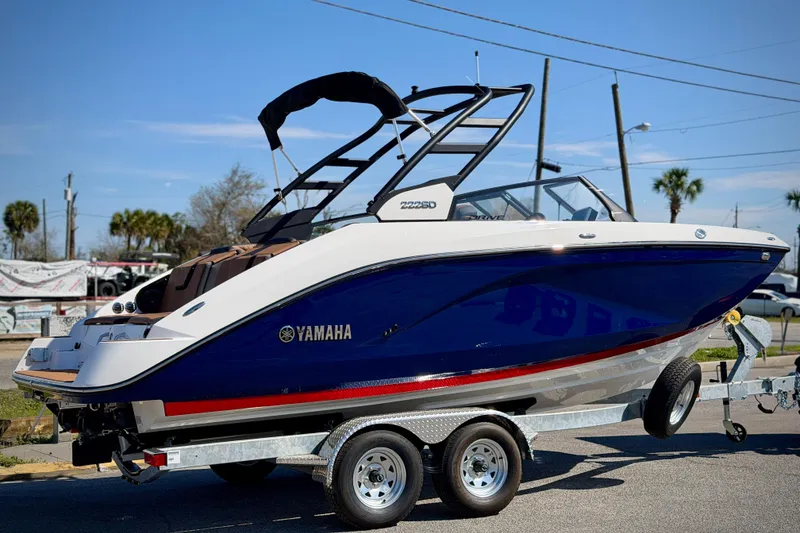 Slide: The Image of 2026 Yamaha Boats 222SD on trailer, sleek blue and white design, outdoor display. - 4