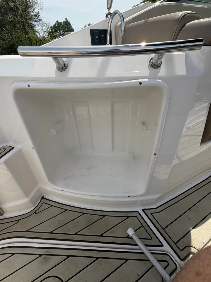 Slide: The Image of Regal 28 Express 2013 boat storage compartment with wood deck. - 12