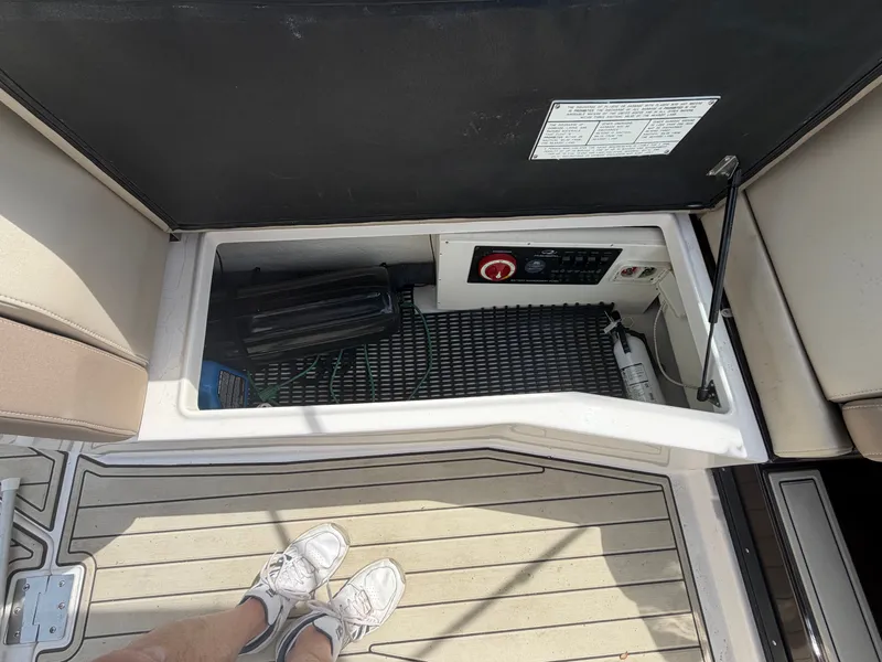 Slide: The Image of Regal 28 Express 2013 boat compartment with storage and controls. - 16
