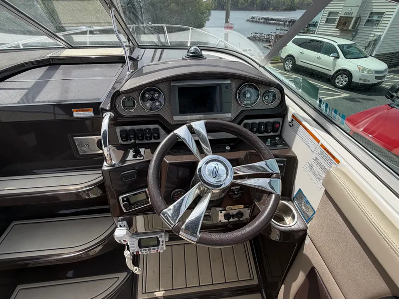 Slide: The Image of Cockpit of a 2013 Regal 28 Express boat with modern instruments. - 18