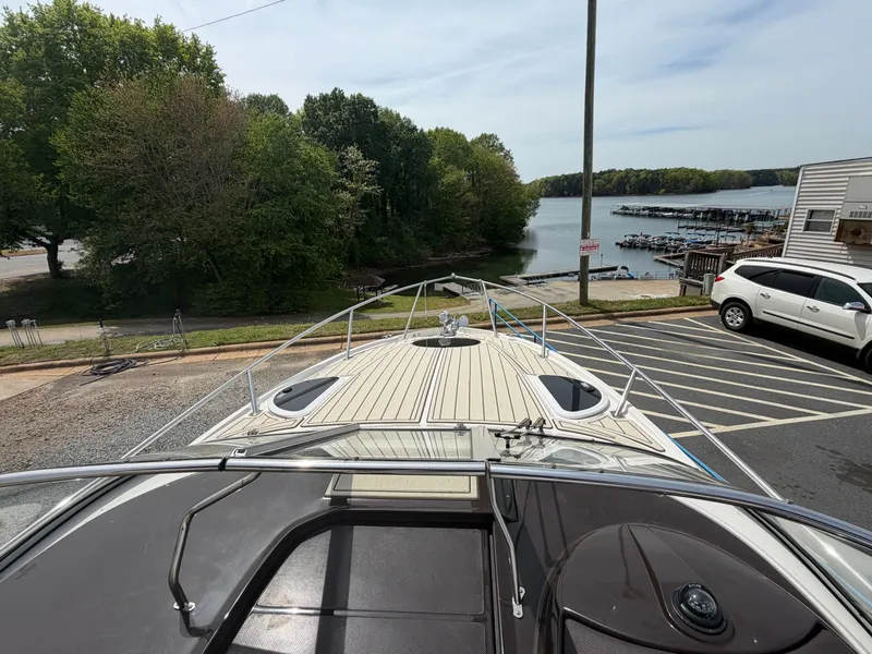 Slide: The Image of 2013 Regal 28 Express boat on trailer near lake. - 22