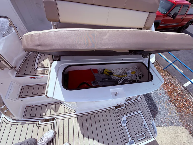 Slide: The Image of Regal 28 Express 2013 boat with open storage compartment and accessories. - 23