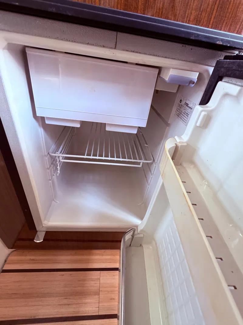 Slide: The Image of Empty fridge in 2013 Regal 28 Express boat. - 26