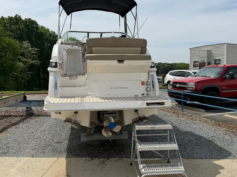 Slide: The Image of Rear view of a 2013 Regal 28 Express boat in a parking area. - 3