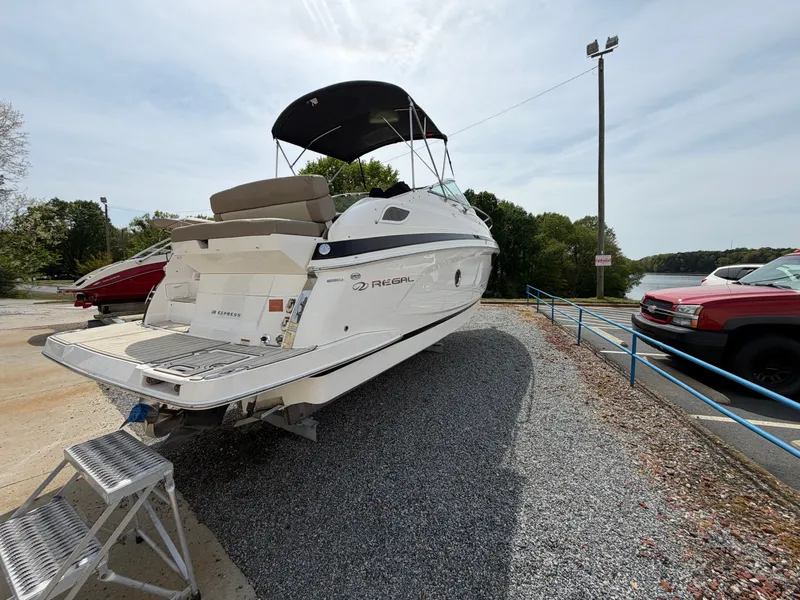 Slide: The Image of 2013 Regal 28 Express boat on a parking lot. - 6