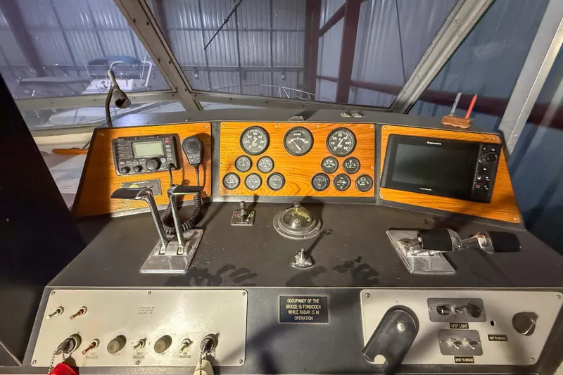 Slide: The Image of Control panel of a 1977 Pacemaker FB Motor Yacht with gauges and navigation equipment. - 11