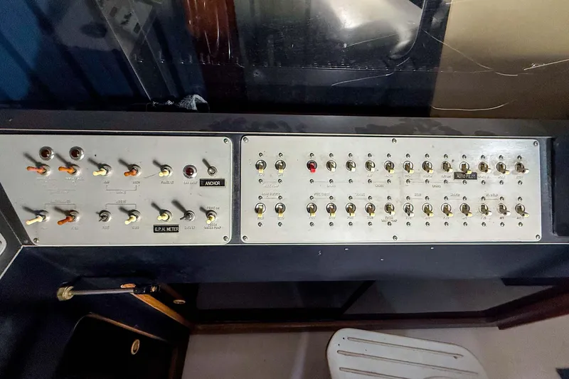 Slide: The Image of Control panel of a 1977 Pacemaker FB Motor Yacht with various switches and indicators. - 12