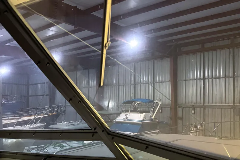 Slide: The Image of Indoor view of a 1977 Pacemaker FB Motor Yacht in a dimly lit storage facility. - 16
