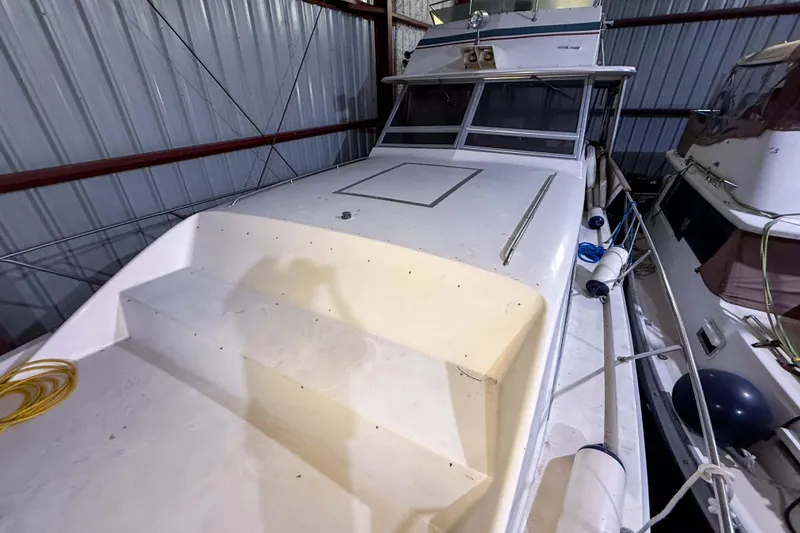 Slide: The Image of 1977 Pacemaker FB Motor Yacht in storage, showcasing deck and cabin details. - 19
