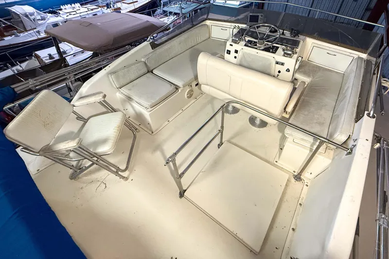 Slide: The Image of 1977 Pacemaker FB Motor Yacht cockpit with white seating and steering console. - 20