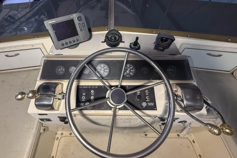 Slide: The Image of 1977 Pacemaker FB Motor Yacht helm with steering wheel and navigation instruments. - 22