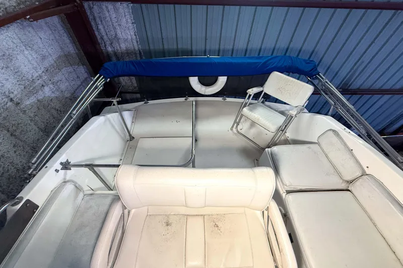 Slide: The Image of 1977 Pacemaker FB Motor Yacht interior with white seating and blue canopy. - 23