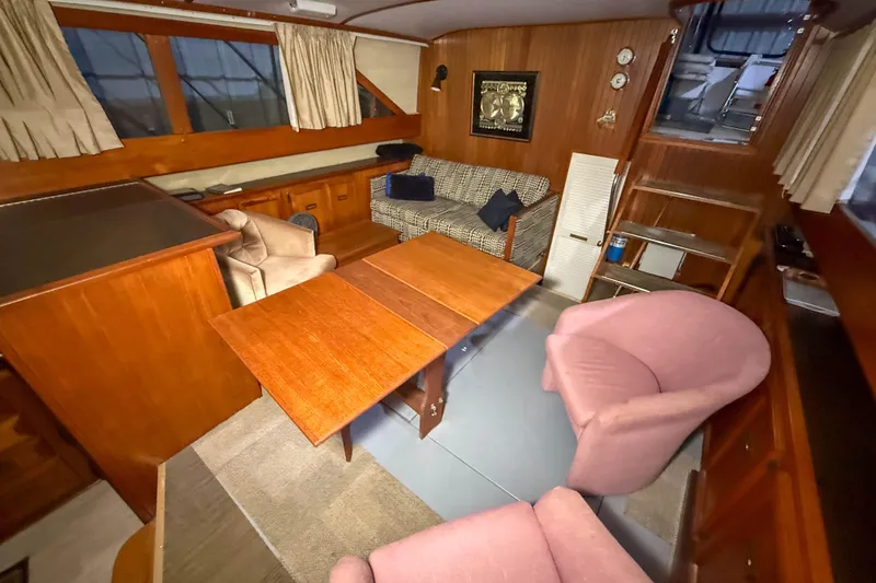 Slide: The Image of Interior of a 1977 Pacemaker FB Motor Yacht with wood paneling and cozy seating. - 25