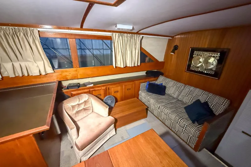 Slide: The Image of Interior of 1977 Pacemaker FB Motor Yacht with cozy seating and wooden accents. - 26