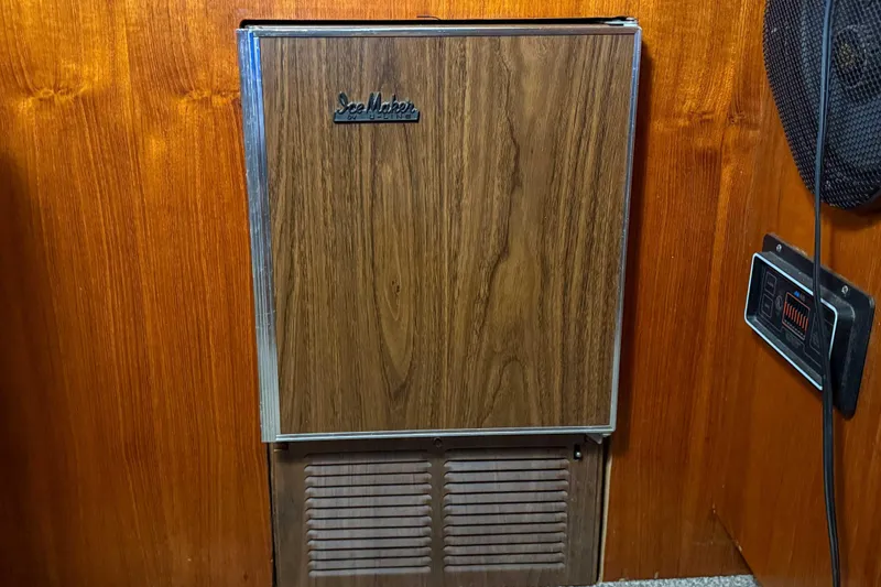 Slide: The Image of Wood-paneled refrigerator door on a 1977 Pacemaker FB Motor Yacht interior. - 27