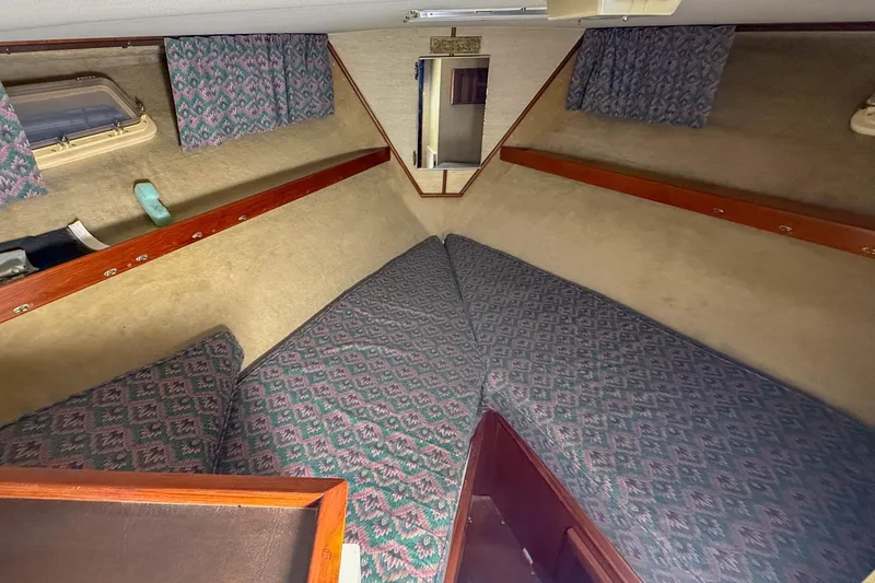 Slide: The Image of 1977 Pacemaker FB Motor Yacht cabin interior with patterned cushions and wooden accents. - 33