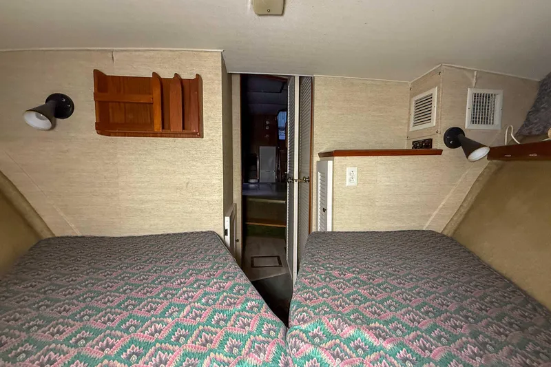 Slide: The Image of Interior cabin of a 1977 Pacemaker FB Motor Yacht with twin beds and vintage decor. - 34