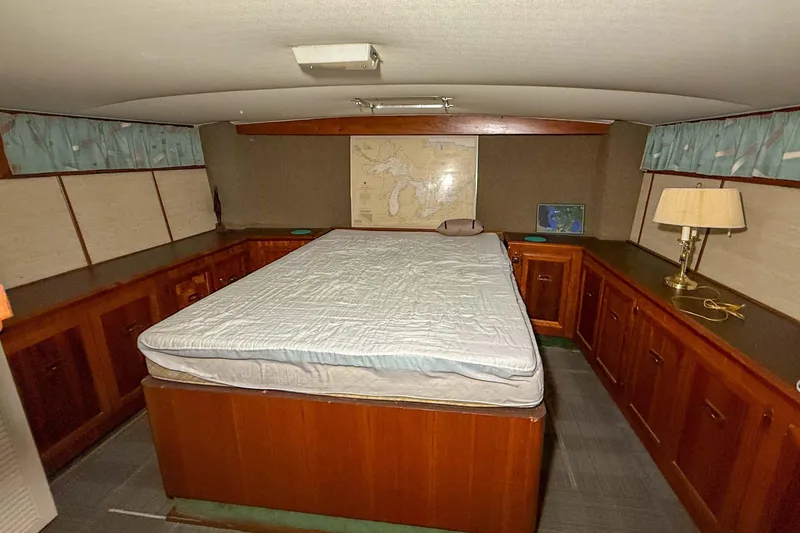 Slide: The Image of Cozy bedroom interior of a 1977 Pacemaker FB Motor Yacht with wooden cabinetry. - 35