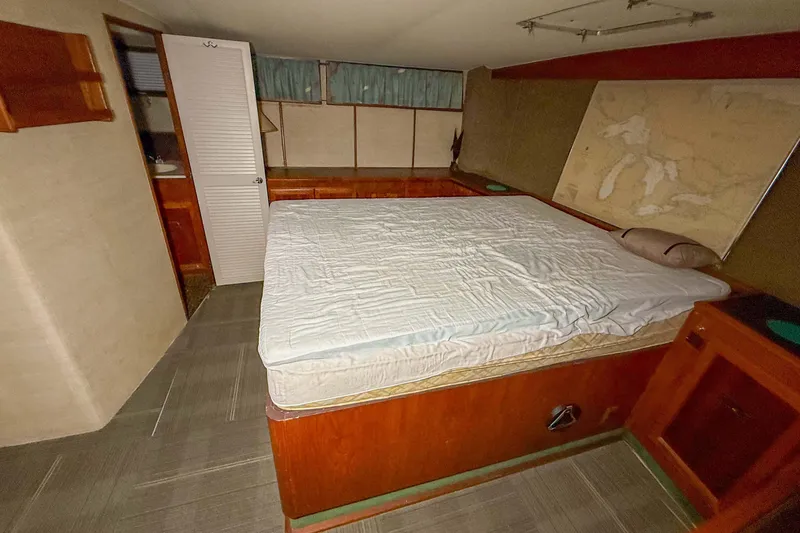 Slide: The Image of Interior cabin of a 1977 Pacemaker FB Motor Yacht with bed and nautical map. - 36