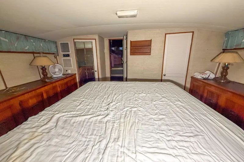 Slide: The Image of Interior of 1977 Pacemaker FB Motor Yacht bedroom with bed, lamps, and fan. - 40