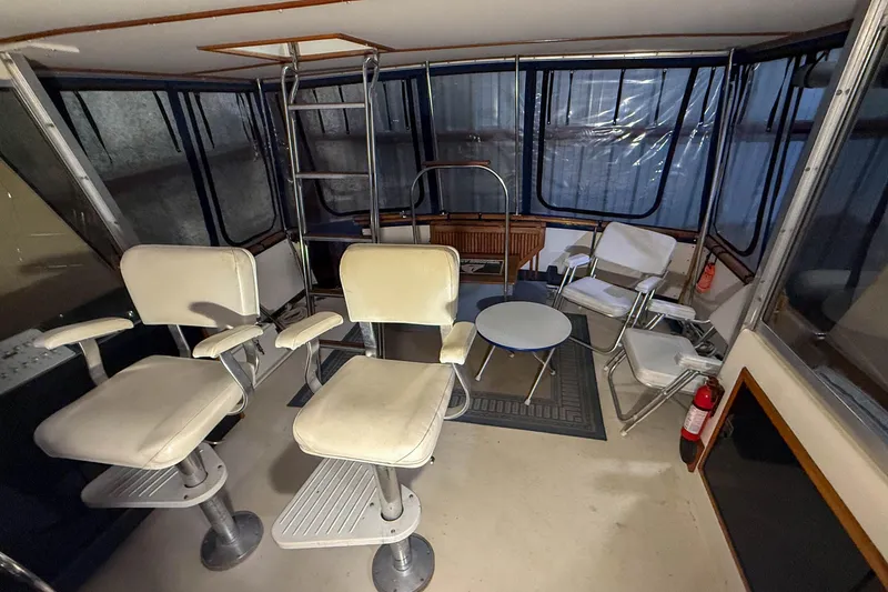 Slide: The Image of Interior of a 1977 Pacemaker FB Motor Yacht with seating and a small table. - 5