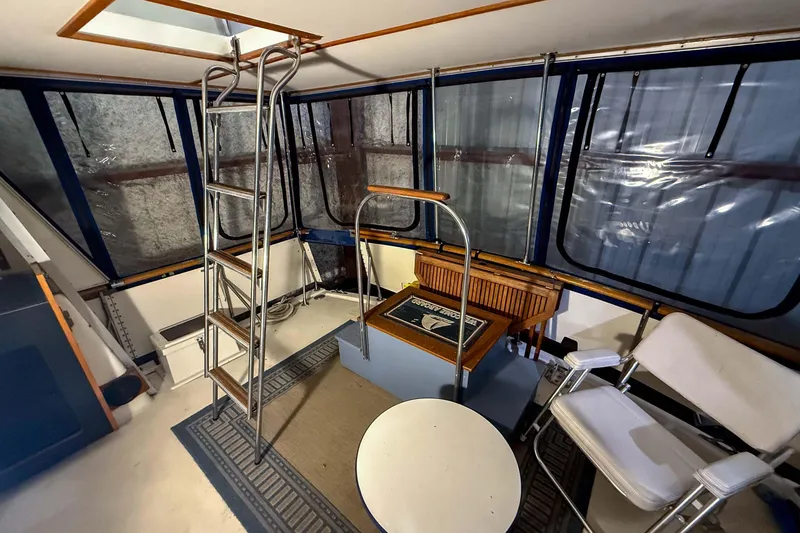 Slide: The Image of Interior of 1977 Pacemaker FB Motor Yacht with seating, ladder, and windows. - 6
