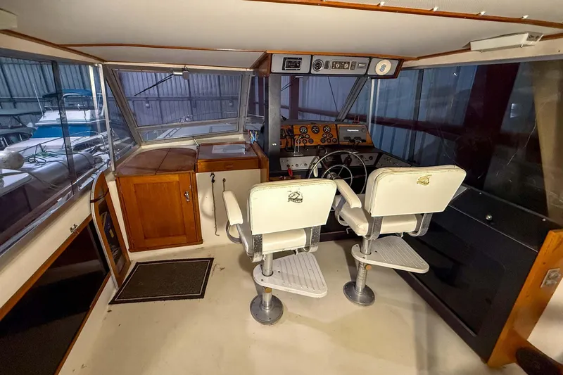 Slide: The Image of Interior of a 1977 Pacemaker FB Motor Yacht cockpit with steering wheel and control panel. - 7