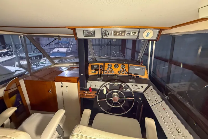 Slide: The Image of Interior view of a 1977 Pacemaker FB Motor Yacht cockpit with steering wheel and control panel. - 8