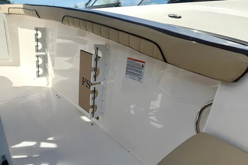 Slide: The Image of Interior view of 2026 Yamaha Boats 252 FSH Sport, featuring cushioned seating and storage compartments. - 11