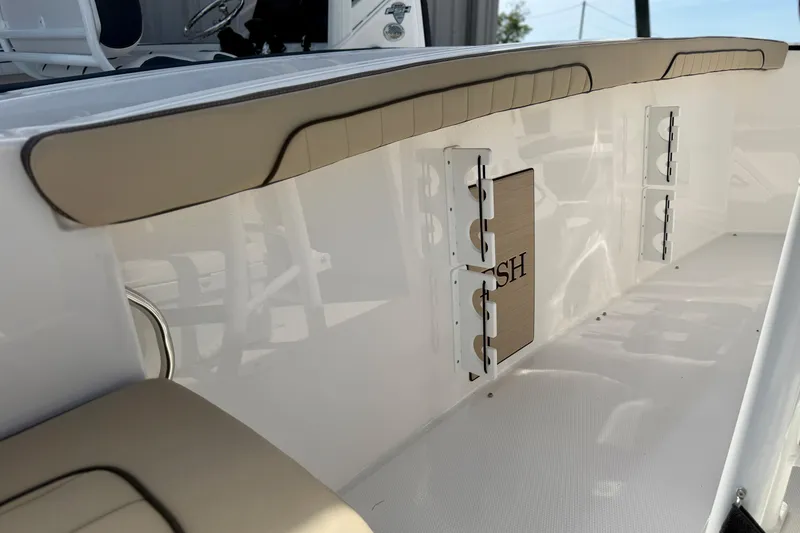 Slide: The Image of 2026 Yamaha Boats 252 FSH Sport interior detail with beige seating and storage compartments. - 12