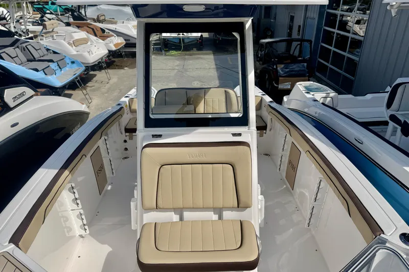 Slide: The Image of 2026 Yamaha Boats 252 FSH Sport interior with tan seating and sleek design. - 15