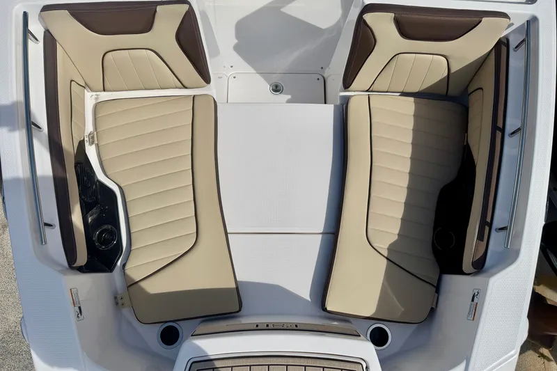 Slide: The Image of 2026 Yamaha Boats 252 FSH Sport interior seating, featuring beige and brown cushioned seats. - 16