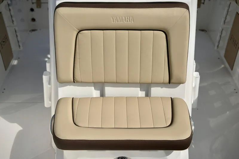 Slide: The Image of 2026 Yamaha Boats 252 FSH Sport beige seat with embossed logo. - 31